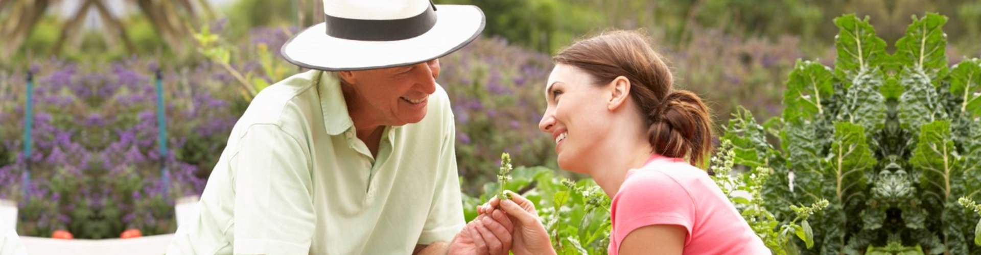 senior man and caregiver at the garden